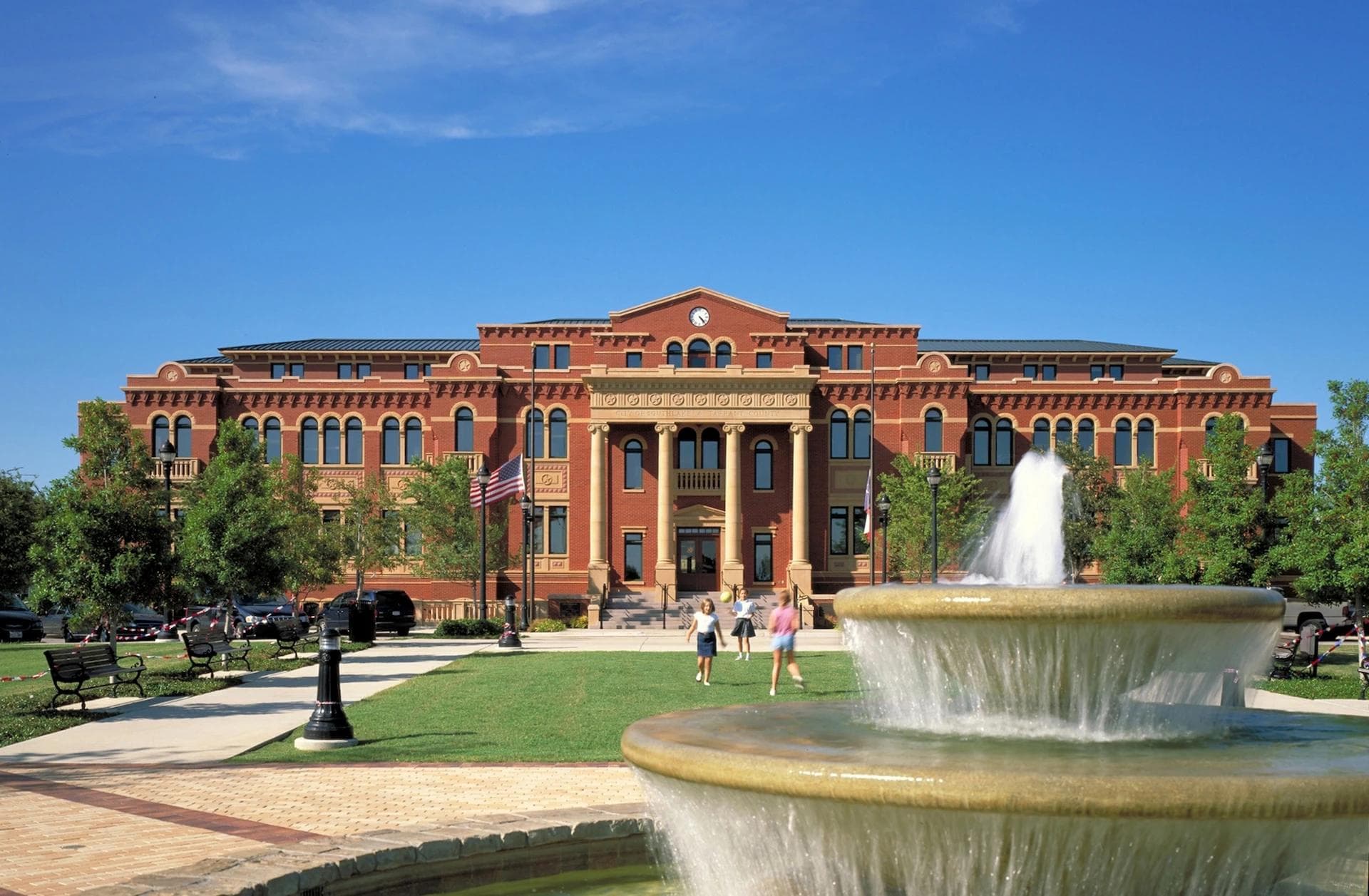 Southlake Town Hall with fountain and pedestrians on a clear day.