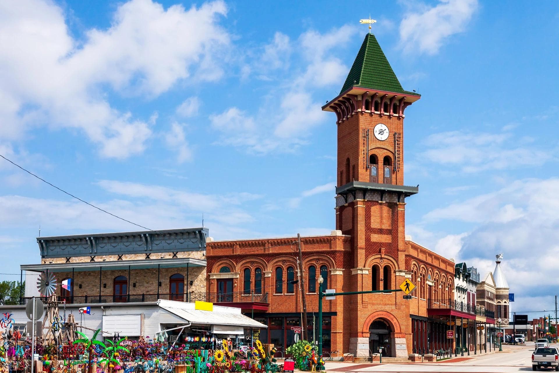 Historic Grapevine clock tower and downtown shops under a bright blue sky.