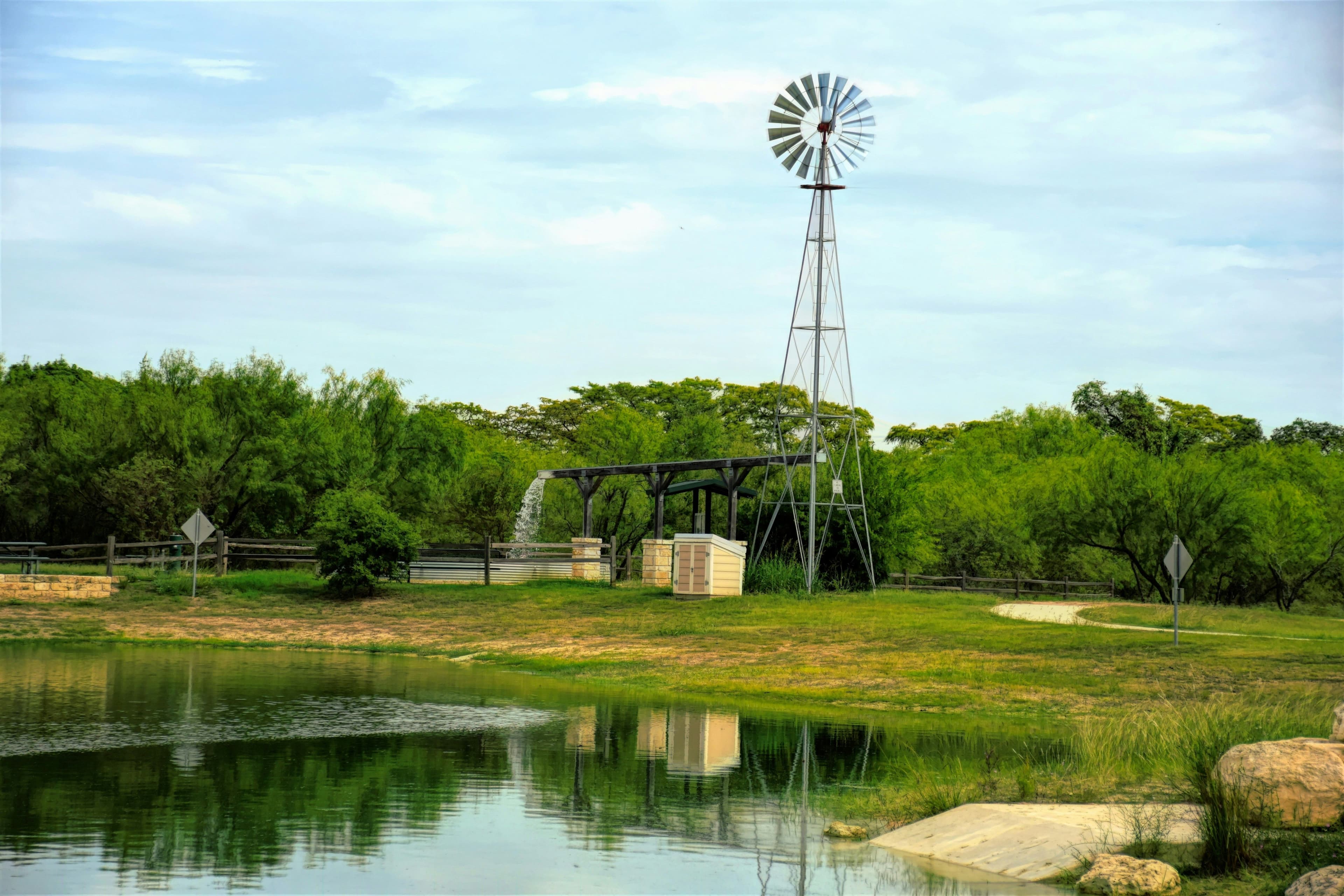 Scenic pond and watermill in Argyle, Texas on a clear day.